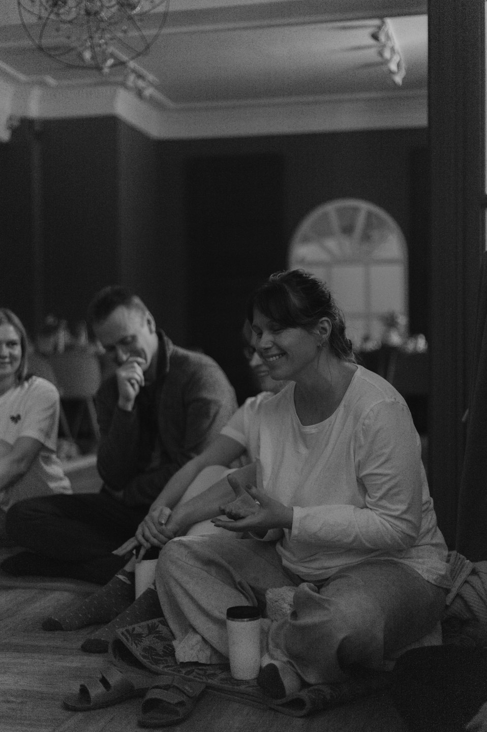 A woman speaks to a group during an indoor workshop.
